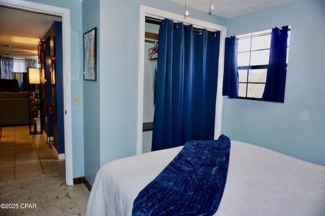 bedroom with light tile patterned flooring