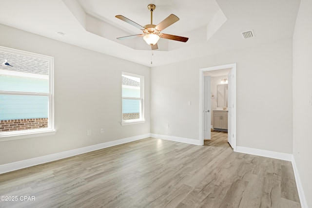 1202 Danley St, Panama City, FL 32404 - unfurnished room featuring baseboards, a ceiling fan, light wood-style floors, visible vents, and a tray ceiling
