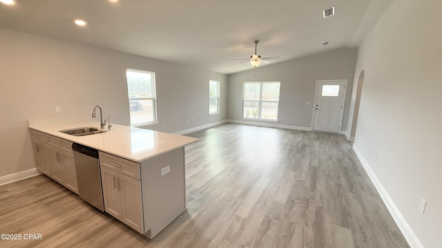 kitchen featuring vaulted ceiling, sink, stainless steel dishwasher, light hardwood / wood-style floors, and kitchen peninsula