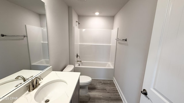 full bathroom with vanity, hardwood / wood-style floors, shower / bathtub combination, and toilet