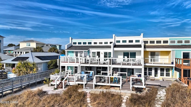 back of property with a wooden deck