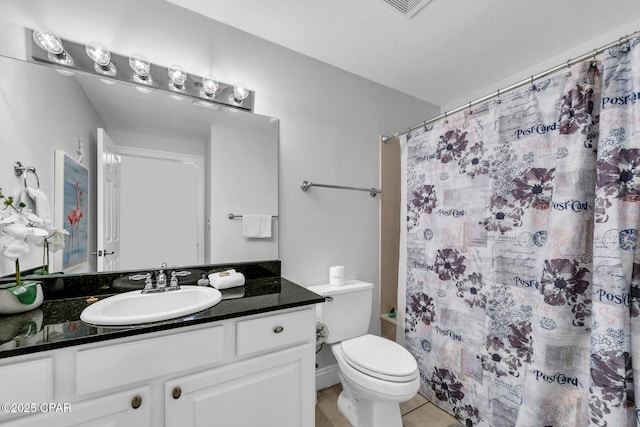 bathroom featuring vanity, toilet, curtained shower, and tile patterned flooring