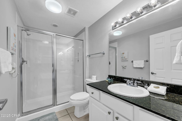 bathroom featuring tile patterned floors, toilet, an enclosed shower, and vanity