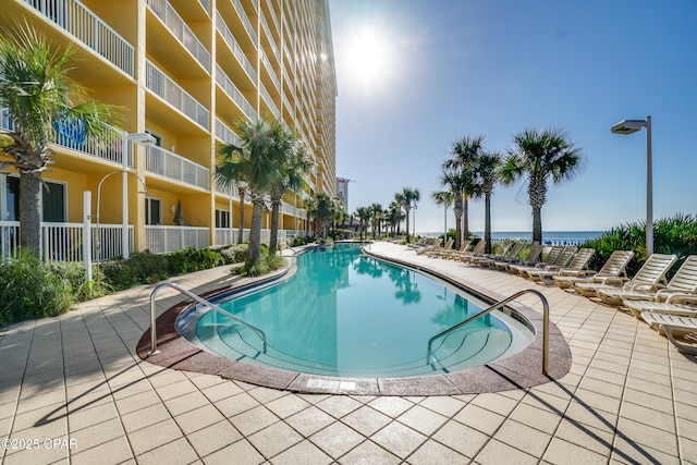 view of swimming pool with a water view