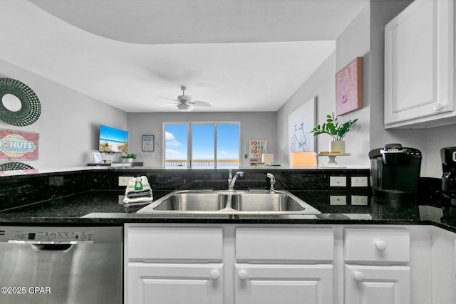 kitchen with sink, ceiling fan, dark stone countertops, white cabinets, and stainless steel dishwasher