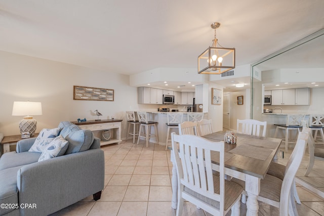 dining space featuring a chandelier and light tile patterned floors