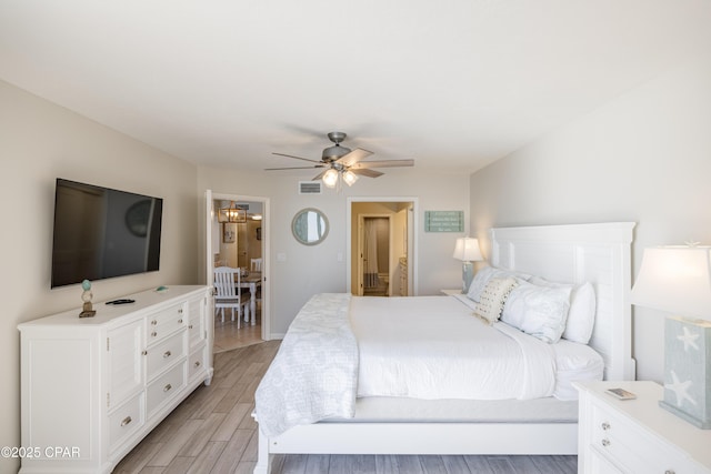 bedroom with ceiling fan and light hardwood / wood-style floors