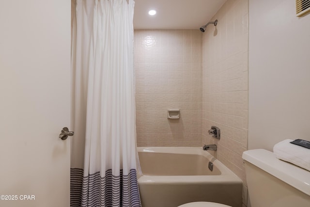 bathroom featuring shower / bath combination with curtain and toilet