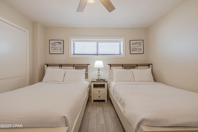 bedroom featuring ceiling fan and light hardwood / wood-style flooring