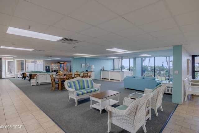 living room featuring a paneled ceiling, pool table, and light tile patterned floors