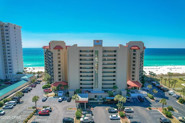 bird's eye view with a water view and a beach view