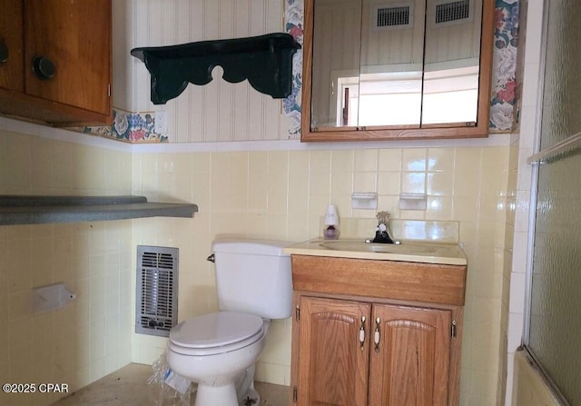 bathroom featuring vanity, tile walls, toilet, and walk in shower