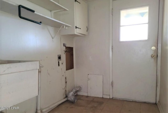 washroom featuring cabinets, light tile patterned flooring, and hookup for an electric dryer