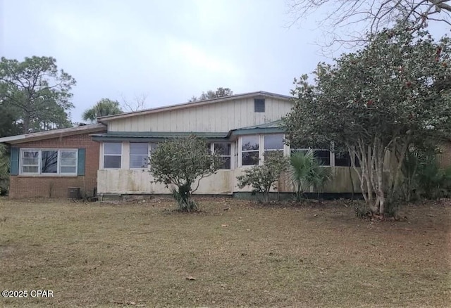 view of side of home featuring a yard and cooling unit