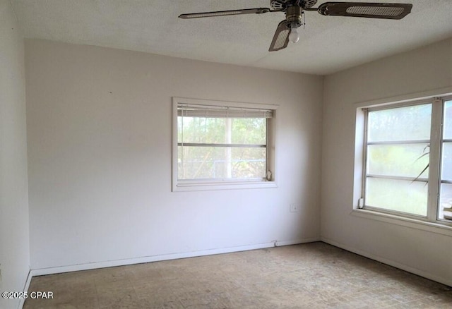 spare room with ceiling fan, a textured ceiling, and a healthy amount of sunlight