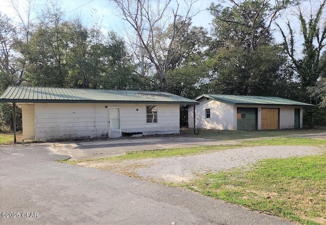 view of front facade with an outbuilding and a garage