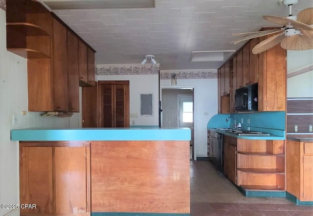 kitchen featuring dishwashing machine, sink, and ceiling fan