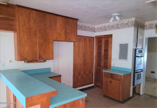 kitchen featuring ornamental molding and stainless steel double oven