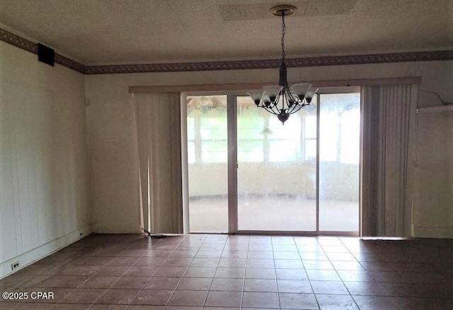 unfurnished dining area with a textured ceiling, tile patterned floors, a chandelier, and a healthy amount of sunlight