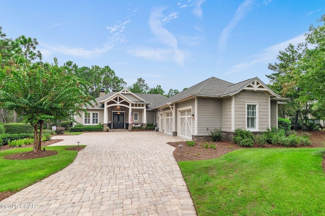 22207 Fox Glenn Trce, Panama City Beach, FL 32413 - craftsman inspired home with decorative driveway, a garage, a front yard, and stone siding