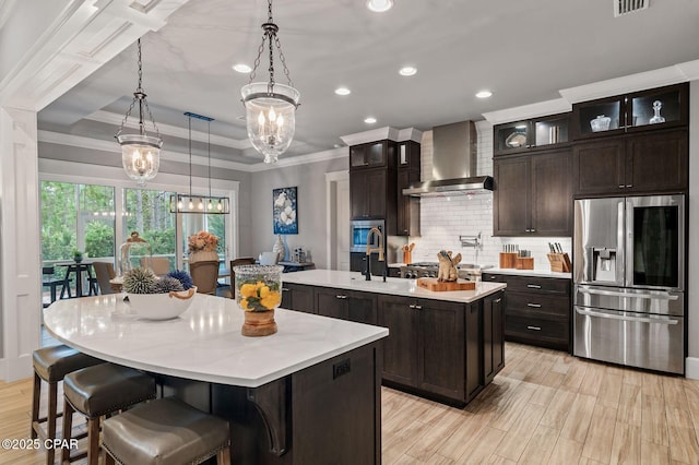 22207 Fox Glenn Trce, Panama City Beach, FL 32413 - kitchen featuring stainless steel fridge, wall chimney range hood, a kitchen island with sink, a chandelier, and light countertops
