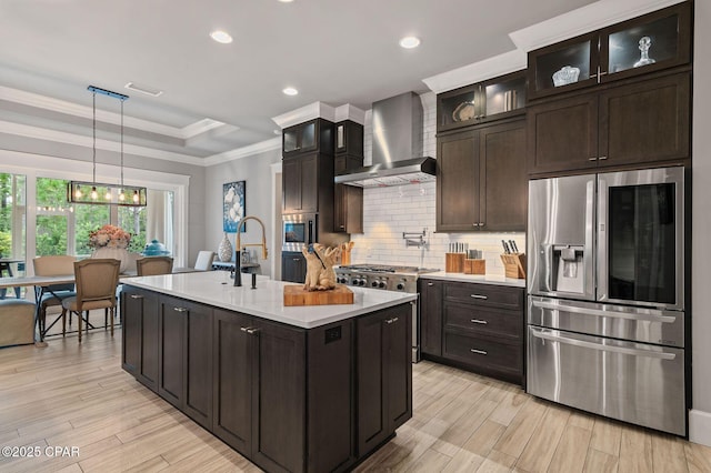 22207 Fox Glenn Trce, Panama City Beach, FL 32413 - kitchen featuring stainless steel appliances, wall chimney exhaust hood, light countertops, a raised ceiling, and tasteful backsplash