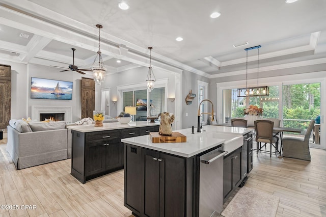 22207 Fox Glenn Trce, Panama City Beach, FL 32413 - kitchen with dishwasher, a center island with sink, a ceiling fan, open floor plan, and crown molding