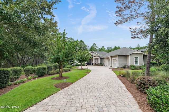 22207 Fox Glenn Trce, Panama City Beach, FL 32413 - view of front facade with decorative driveway, an attached garage, and a front lawn
