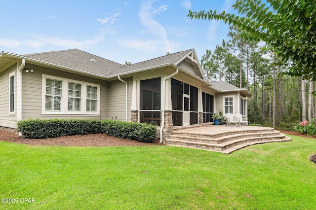 22207 Fox Glenn Trce, Panama City Beach, FL 32413 - rear view of house featuring a yard, a sunroom, and roof with shingles