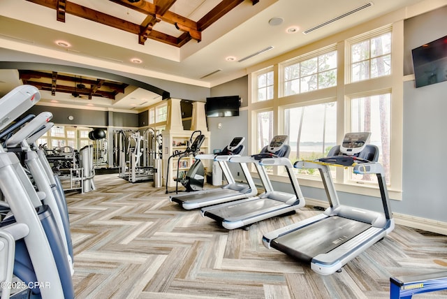 22207 Fox Glenn Trce, Panama City Beach, FL 32413 - gym featuring a towering ceiling, beam ceiling, arched walkways, coffered ceiling, and ornate columns