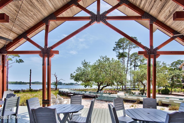 22207 Fox Glenn Trce, Panama City Beach, FL 32413 - wooden deck with outdoor dining space and a water view