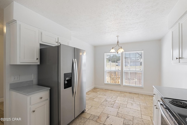 kitchen with an inviting chandelier, a textured ceiling, hanging light fixtures, appliances with stainless steel finishes, and white cabinets