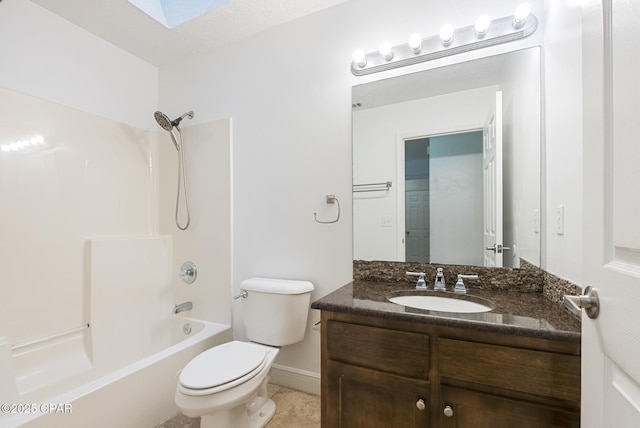 full bathroom featuring vanity, a skylight, shower / tub combination, and toilet