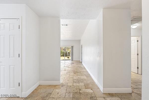 hallway with a textured ceiling