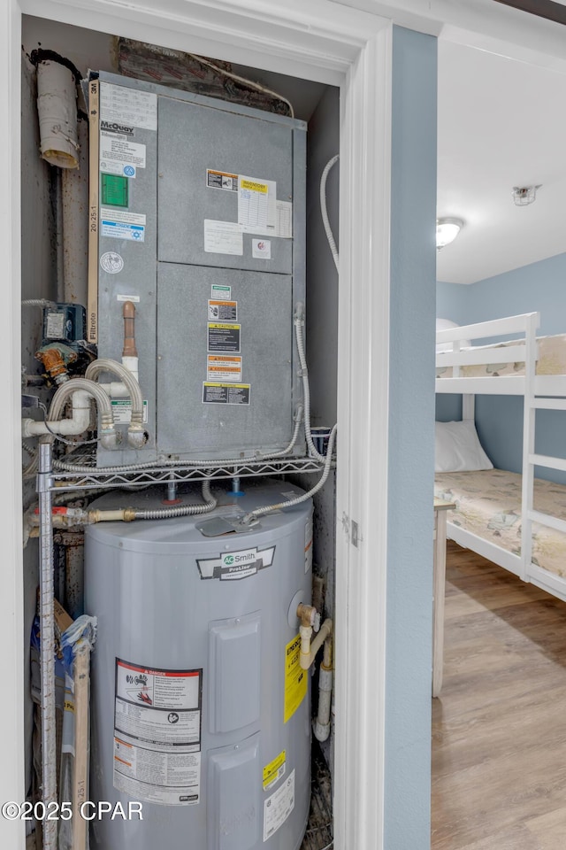 utility room with electric water heater