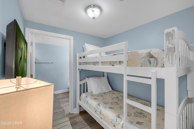 bedroom with wood-type flooring