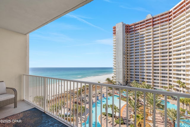 balcony featuring a water view and a view of the beach