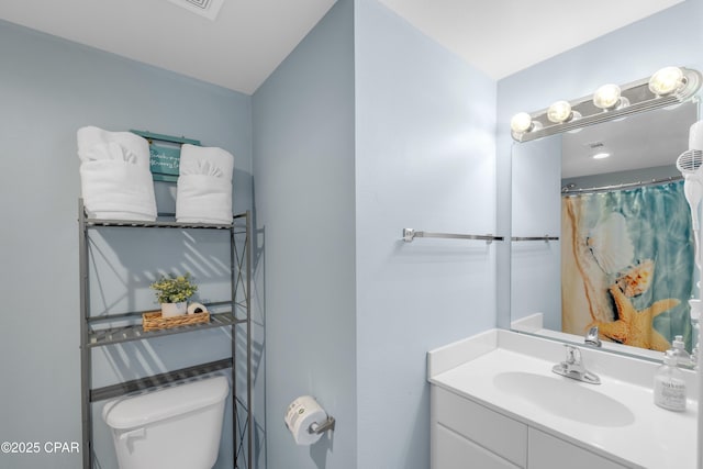 bathroom with vanity and toilet