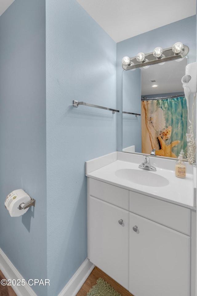 bathroom with vanity and hardwood / wood-style flooring