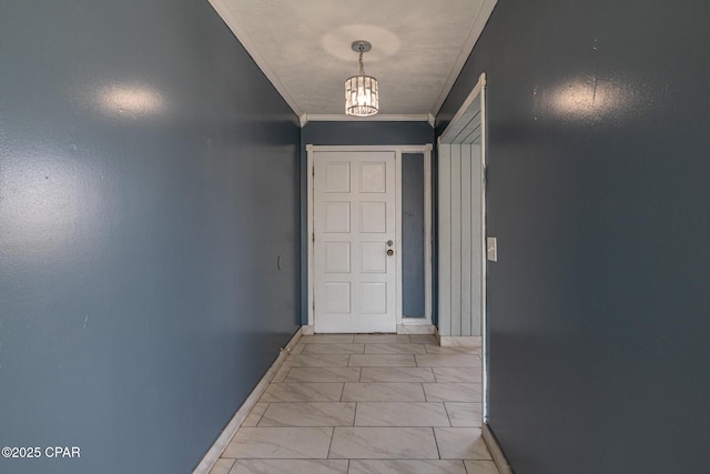 interior space with an inviting chandelier, baseboards, marble finish floor, and ornamental molding
