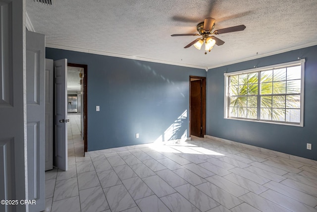 spare room with ceiling fan, ornamental molding, and a textured ceiling