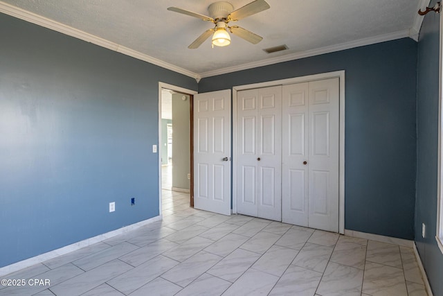 unfurnished bedroom with a closet, marble finish floor, ornamental molding, and visible vents