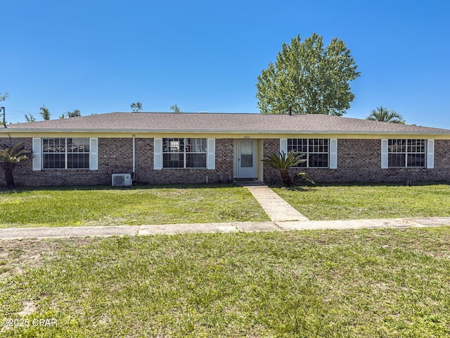 single story home with brick siding and a front lawn