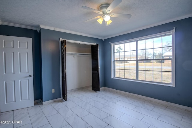 unfurnished bedroom with ceiling fan, ornamental molding, a closet, and a textured ceiling