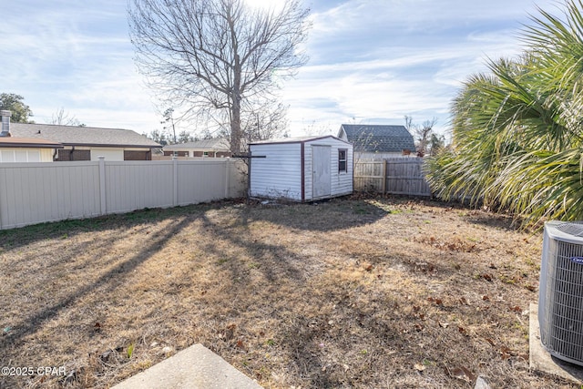 view of yard featuring a fenced backyard, a storage shed, central air condition unit, and an outdoor structure