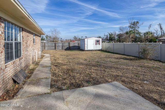 view of yard featuring a patio, an outbuilding, a fenced backyard, and a storage unit