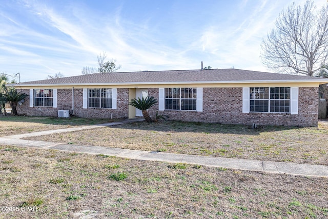 ranch-style home with a front yard and brick siding