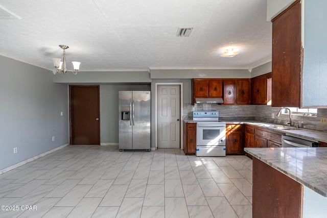 kitchen featuring sink, tasteful backsplash, light stone counters, pendant lighting, and stainless steel appliances