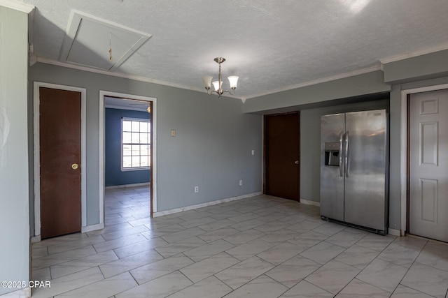 empty room featuring crown molding, baseboards, an inviting chandelier, and a textured ceiling