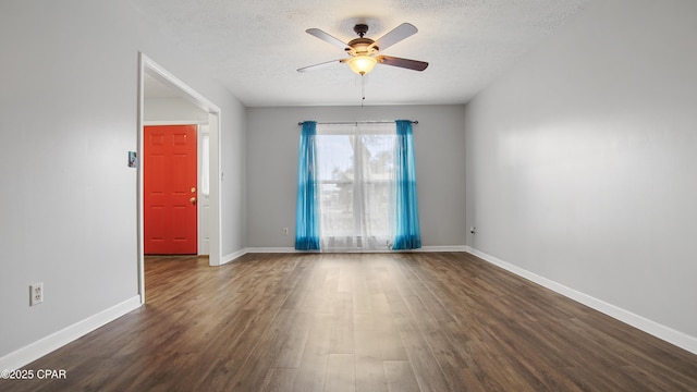 empty room featuring ceiling fan, dark hardwood / wood-style floors, and a textured ceiling